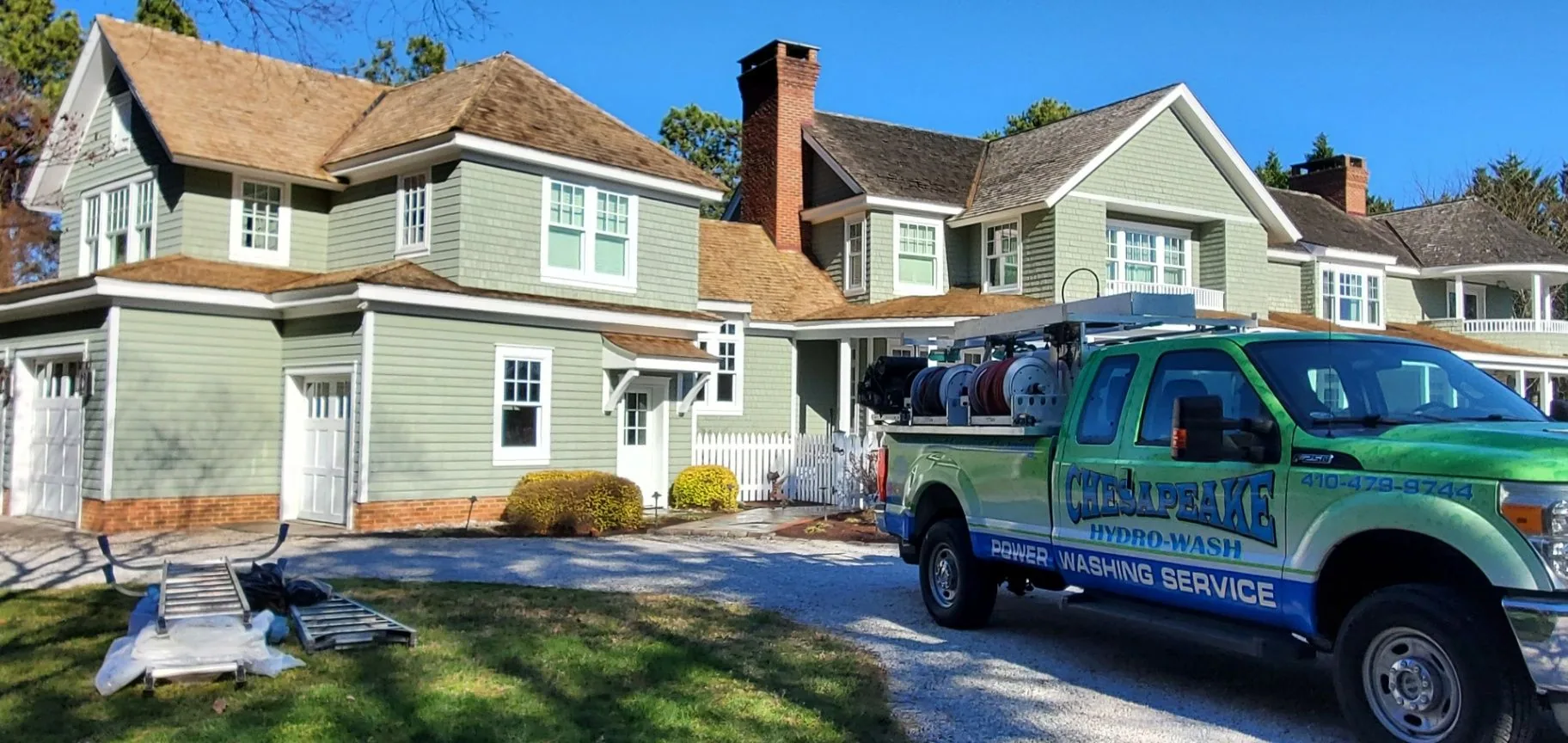 Chesapeake Hydro-Wash truck and equipment outside a large Maryland home