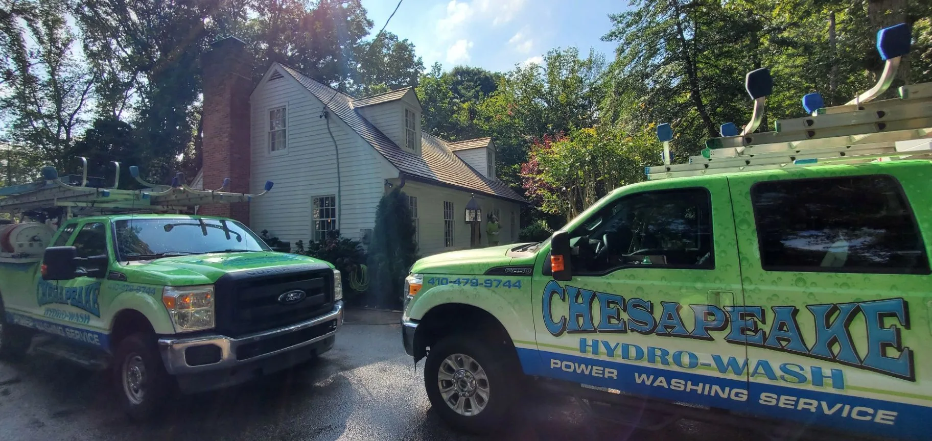 Chesapeake Hydro-Wash trucks parked beside a Maryland home