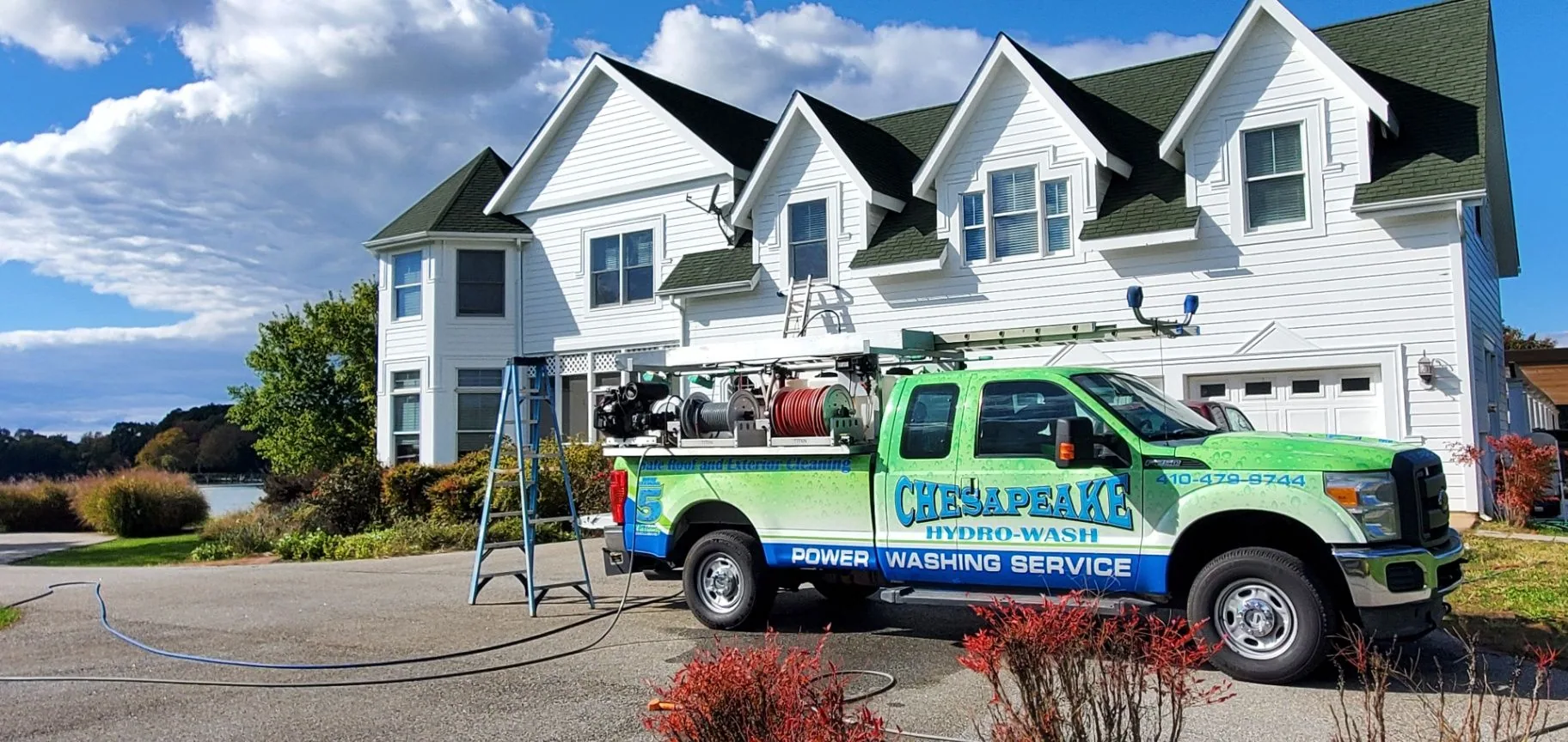 Chesapeake Hydro-Wash truck set up for house washing beside a Maryland home