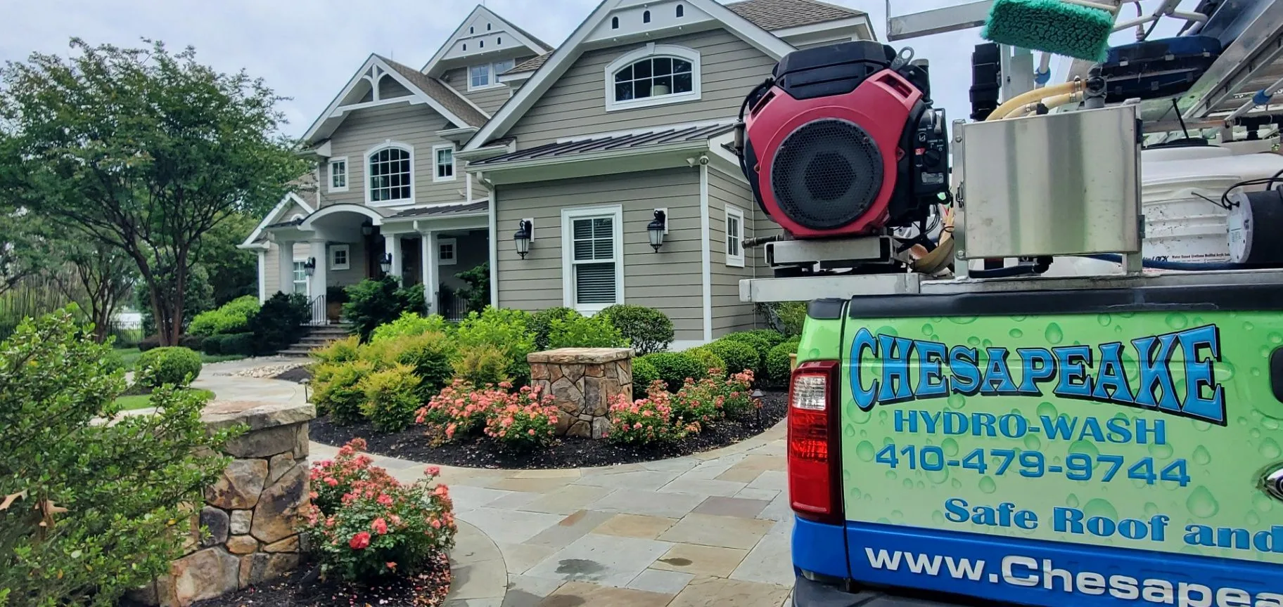 Chesapeake Hydro-Wash truck and cleaning equipment at the front of a Maryland home